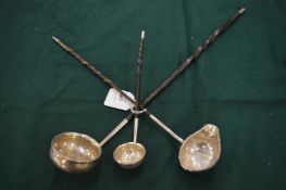 Three toddy ladles.