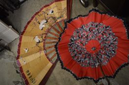 A parasol and a large fan.
