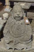 A reconstituted stone garden ornament modelled as Buddha.