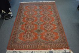 A modern Persian style rug, rust ground with stylised decoration 195cm x 125cm.