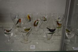 A collection of drinking glasses, each hand painted with birds.