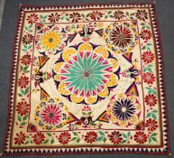 An Indian Rajasthan embroidered floral textile panel, inscribed and inset with small circular mirror