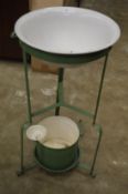An old enamel and wrought iron wash basin.