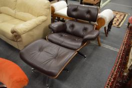 An Eames style armchair with matching foot stool.