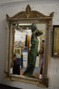 A decorative carved and stained wood pier mirror.