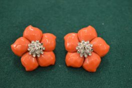A pair of decorative coral ear clips.