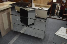 A mirrored three drawer chest.