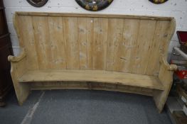 A large pine curved back settle 220cm long x 133cm high.