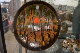 A large Poole pottery Aegean ware charger depicting a landscape with sunset.