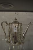 A plated coffee pot with engraved decoration.