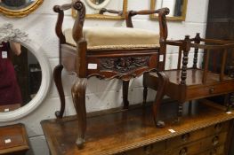 A mahogany music seat.