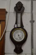 An oak barometer/thermometer.