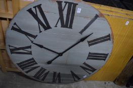 A large modern wooden wall clock.