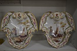 A pair of French porcelain shield shaped dishes with hand painted scenes of boats in a harbour,