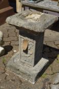 A reconstituted stone bird bath with Celtic design.