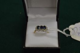 A 9ct gold diamond and sapphire ring.