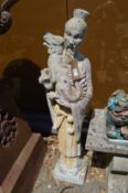 A large reconstituted stone garden figure modelled as a Chinese Emperor holding a dragon.