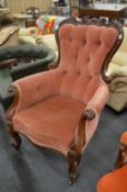 A good Victorian rosewood framed button upholstered armchair.
