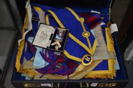 A briefcase containing a quantity of masonic regalia.