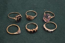 Group of gold and decorative rings.