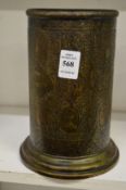 An Islamic engraved brass cylindrical vase.