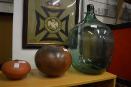 Two pottery vases and a glass carboy.