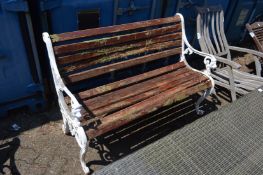 A cast metal and wooden slatted garden bench.