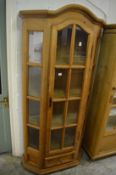 A pine narrow display cabinet.
