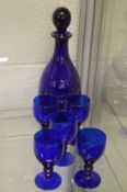 A Bristol blue decanter and five glasses.