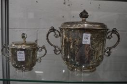 A good large twin handled trophy cup and cover, the body with engraved figures in a landscape,