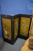 A triple panel folding screen painted with flowers.
