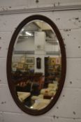An oval wall mirror.