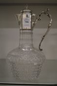 Cut glass claret jug with silver mounts.