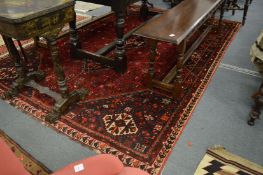 A good large Persian style carpet, red ground with stylised decoration 290cm x 210cm.