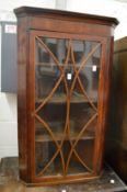 A mahogany hanging corner cabinet.
