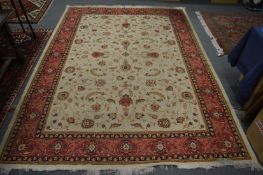 A Persian design machine made carpet, beige ground with floral decoration 280cm x 200cm.