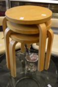 In the manner of Alvar Aalto, a set of three birch ply stacking occasional tables.