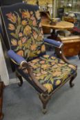 A good Georgian design mahogany framed armchair with leaf carved curving arms, carved cabriole