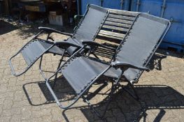Two folding garden chairs.