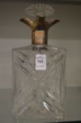 A good heavy cut glass decanter with silver collar.