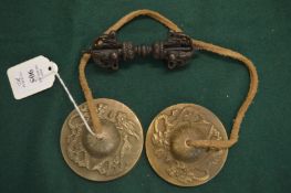 A pair of Chinese bronze hand chimes together with a vajra.