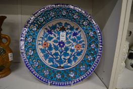 An Iznik style floral decorated dish with pierced border (cracked).