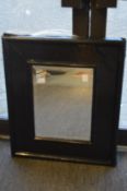 A rectangular wall mirror with distressed painted frame together with another mirror.