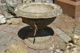 A reconstituted stone circular pedestal garden planter.