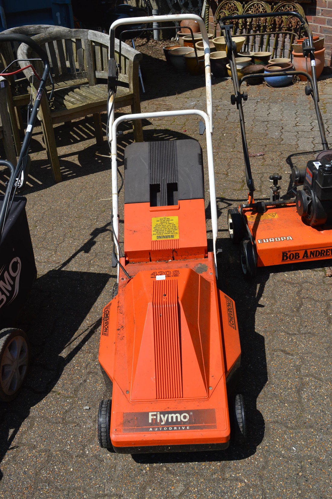 A Flymo electric rotary lawn mower.