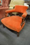 A Victorian low open armchair.