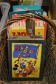 A basket containing children's annuals.