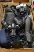 A Nikon spotting scope, a Canon T50 camera and other optical equipment.