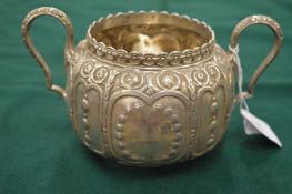 A Victorian embossed silver twin handled sugar bowl.