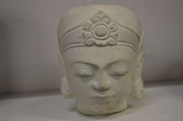 An Indian carved plaster head of a woman.